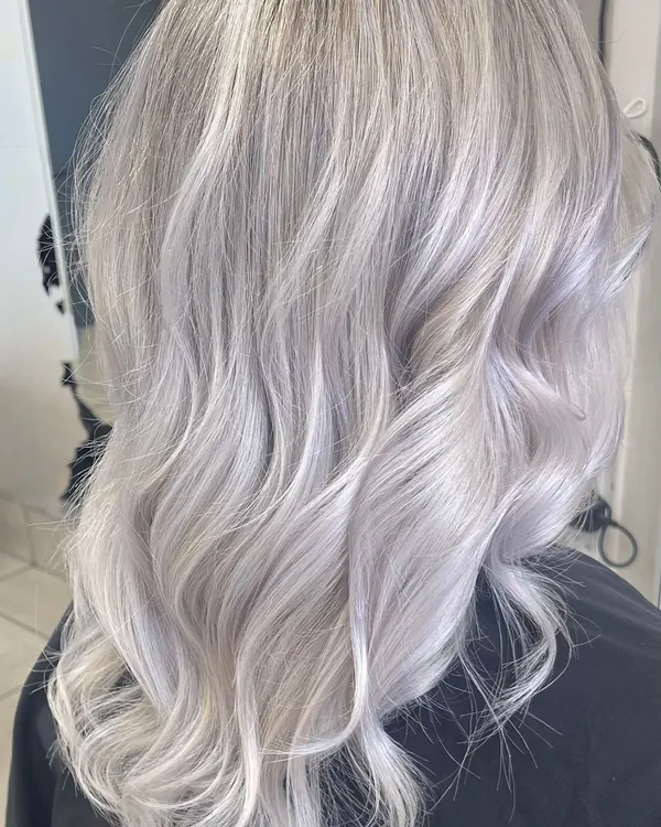 Back view of long wavy hair in icy platinum blonde with cool silve